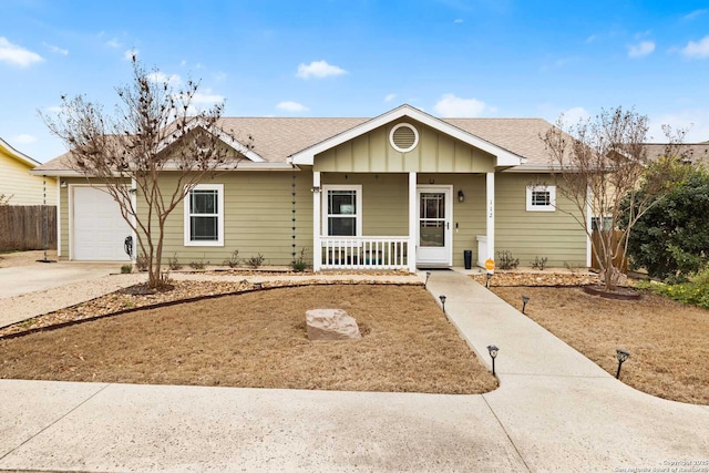 ranch-style home with a porch, concrete driveway, roof with shingles, and an attached garage