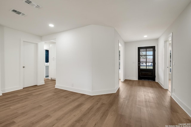 foyer entrance featuring recessed lighting, wood finished floors, visible vents, and baseboards