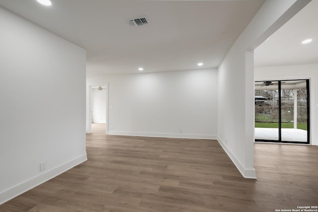 spare room featuring recessed lighting, visible vents, and wood finished floors