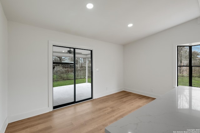 unfurnished room featuring light wood-style floors, recessed lighting, and baseboards