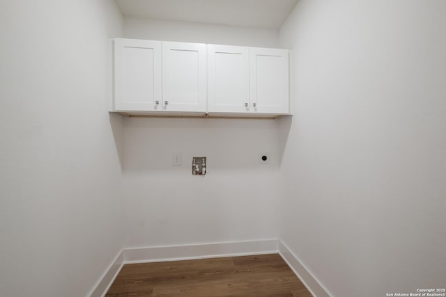 laundry room with cabinet space, baseboards, dark wood-type flooring, and hookup for an electric dryer