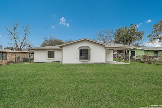 back of property with a patio area, fence, and a yard