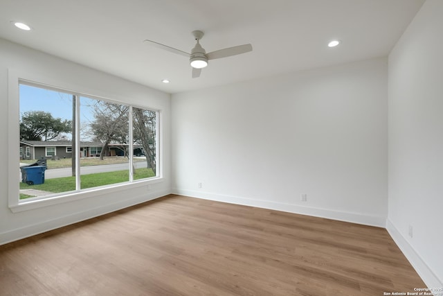 unfurnished room with light wood-style floors, ceiling fan, baseboards, and recessed lighting