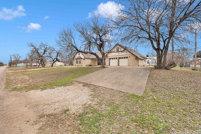 exterior space featuring a front lawn, a residential view, driveway, and an attached garage