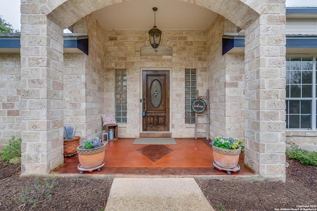 property entrance featuring stone siding