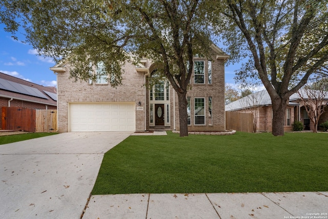 view of front of property with brick siding, fence, concrete driveway, and a front yard