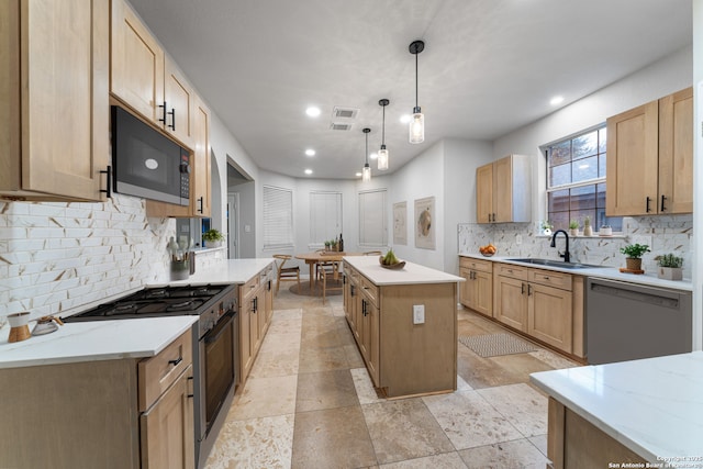 kitchen with stainless steel gas stove, a kitchen island, a sink, black microwave, and dishwashing machine