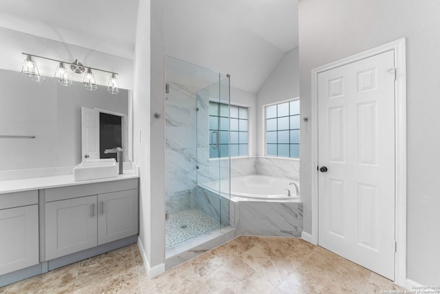 full bath featuring a garden tub, vaulted ceiling, vanity, and a marble finish shower