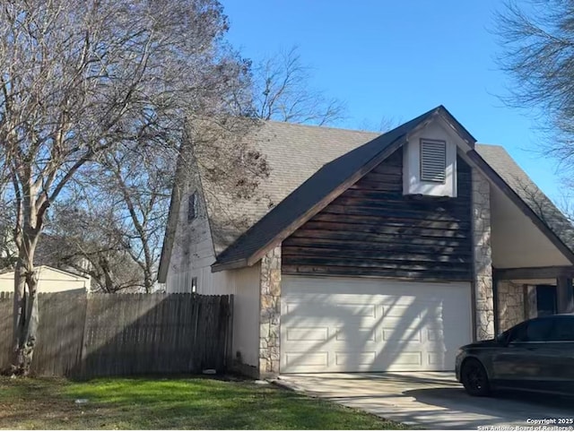 view of home's exterior with a garage, driveway, stone siding, roof with shingles, and fence