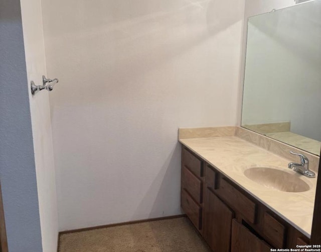 bathroom featuring baseboards and vanity