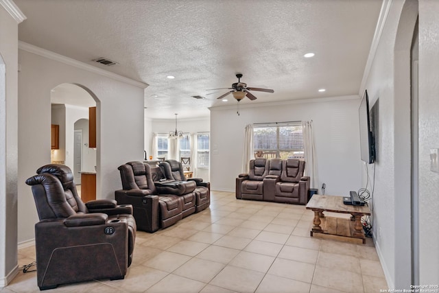 living area featuring ornamental molding, arched walkways, a textured ceiling, and light tile patterned floors