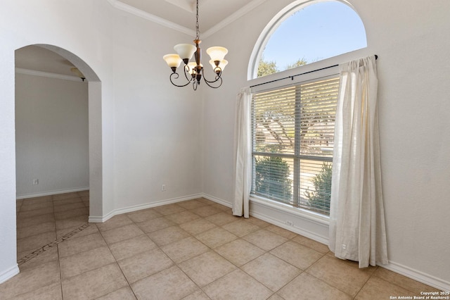 unfurnished room with light tile patterned floors, baseboards, ornamental molding, and arched walkways