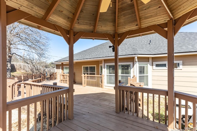 wooden terrace featuring a gazebo and fence