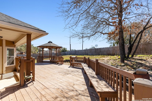 wooden deck featuring a gazebo and a fenced backyard