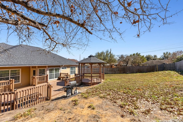 view of yard with a deck, a gazebo, and a fenced backyard