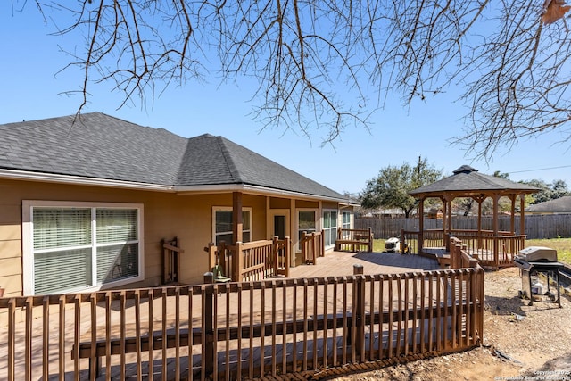 exterior space with area for grilling, fence, and a gazebo