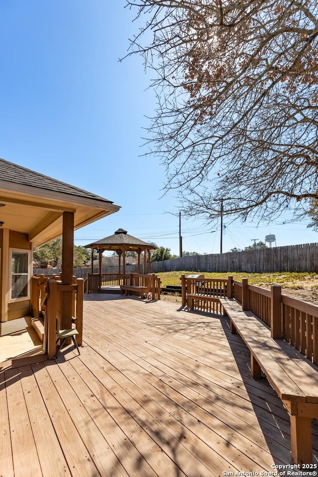 wooden terrace with a gazebo and fence