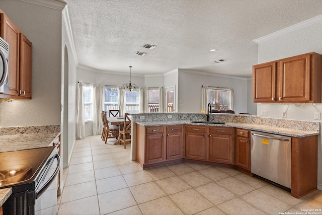 kitchen featuring appliances with stainless steel finishes, a sink, and brown cabinets