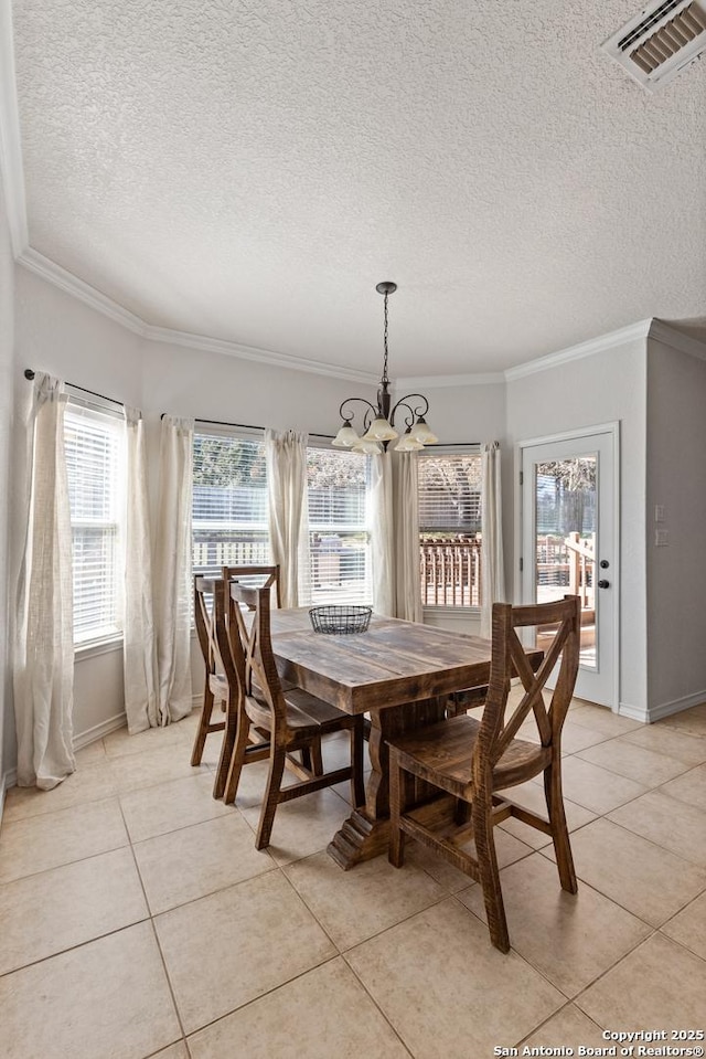 dining area with visible vents, crown molding, a notable chandelier, and light tile patterned floors