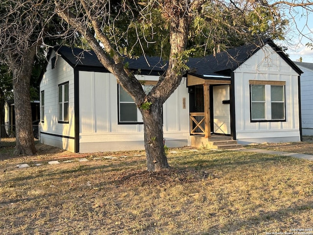 modern inspired farmhouse featuring board and batten siding and a front yard