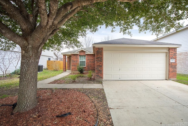 ranch-style house with central AC unit, an attached garage, brick siding, fence, and concrete driveway