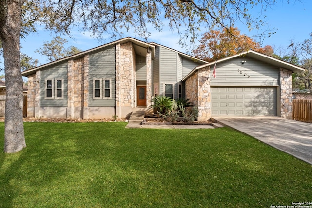 mid-century inspired home with a garage, a front yard, stone siding, and driveway