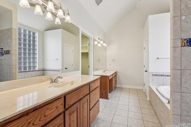 bathroom with lofted ceiling, two vanities, a sink, and tile patterned floors