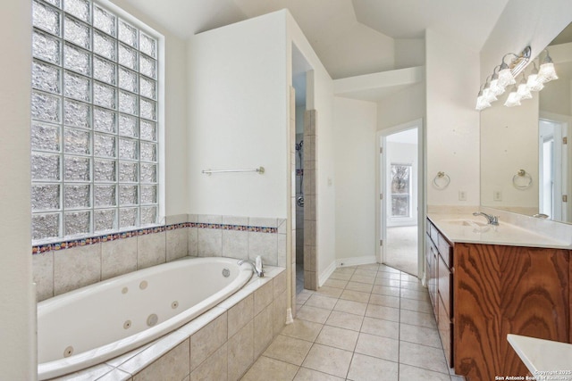 bathroom with a stall shower, tile patterned flooring, vanity, and a whirlpool tub