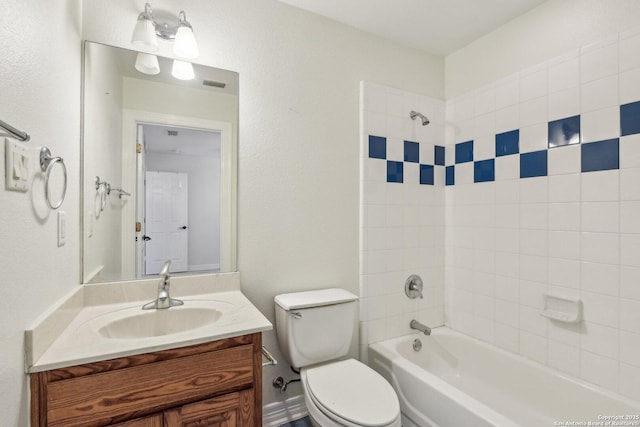 full bathroom featuring toilet, vanity, visible vents, and bathing tub / shower combination