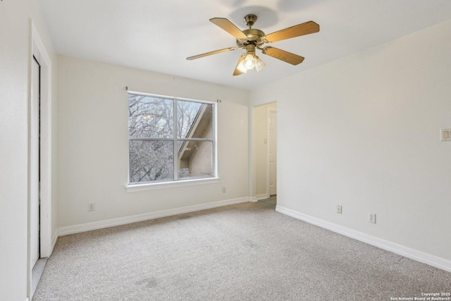 unfurnished bedroom featuring baseboards, a ceiling fan, and light colored carpet