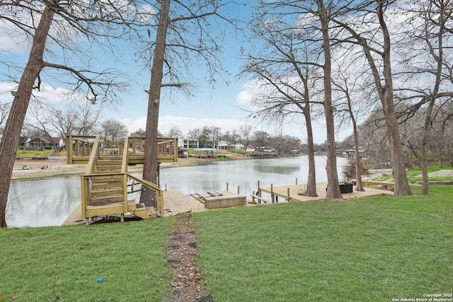 view of yard featuring a water view and a boat dock