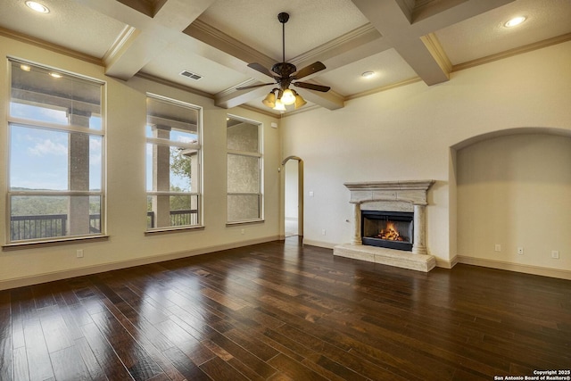 unfurnished living room with coffered ceiling, dark wood-style flooring, visible vents, and baseboards