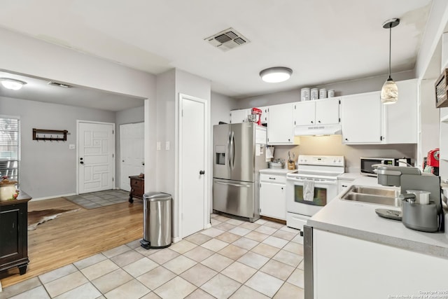 kitchen with visible vents, white cabinets, appliances with stainless steel finishes, light countertops, and under cabinet range hood