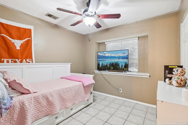 bedroom featuring ceiling fan, light tile patterned flooring, visible vents, and baseboards