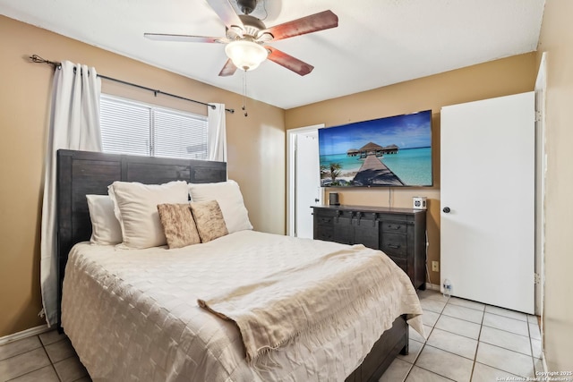 bedroom with baseboards, a ceiling fan, and light tile patterned flooring