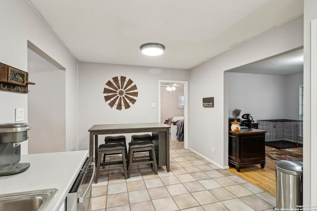 dining area with light tile patterned floors, baseboards, and a ceiling fan