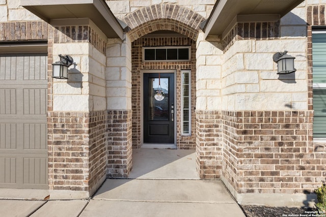 entrance to property featuring stone siding and brick siding