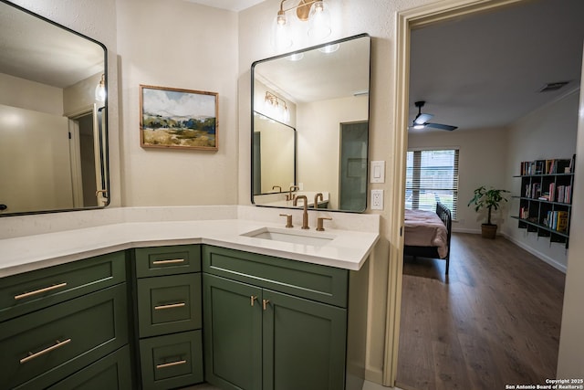 ensuite bathroom featuring visible vents, a ceiling fan, connected bathroom, vanity, and wood finished floors