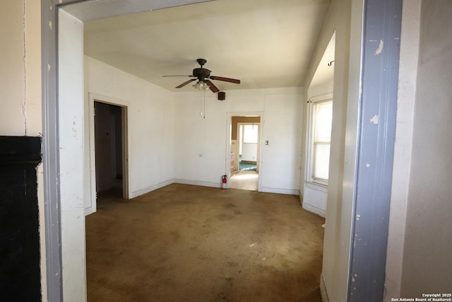 interior space featuring baseboards and a ceiling fan