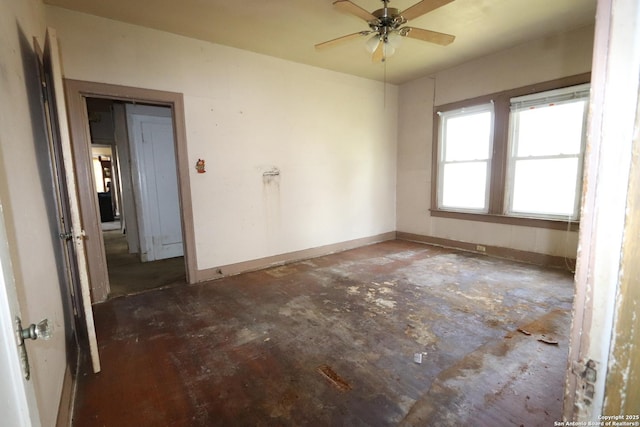 unfurnished room with baseboards and a ceiling fan