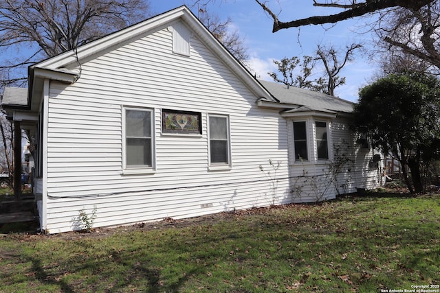 view of side of property with a lawn