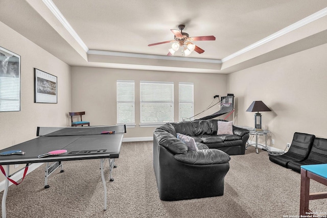 rec room with a tray ceiling, carpet flooring, crown molding, and baseboards