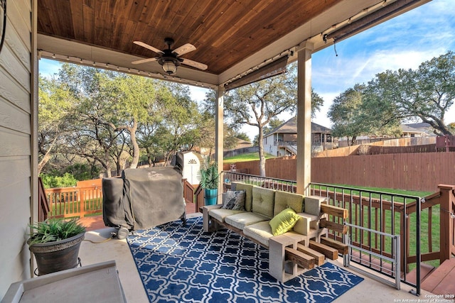 view of patio / terrace with an outbuilding, a fenced backyard, an outdoor hangout area, a ceiling fan, and a shed