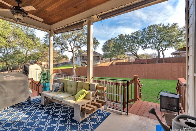 exterior space with ceiling fan, a fenced backyard, an outbuilding, a shed, and an outdoor living space