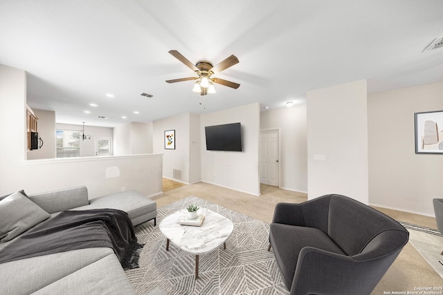 living area featuring light carpet, ceiling fan, and visible vents