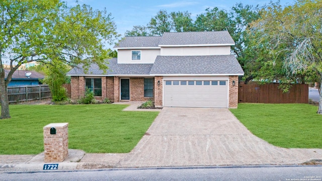 traditional-style house featuring driveway, fence, and a front yard