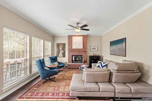 living room featuring a brick fireplace, ceiling fan, ornamental molding, and wood finished floors