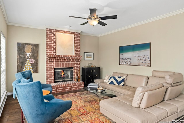 living area featuring ceiling fan, ornamental molding, dark wood-style flooring, and a fireplace