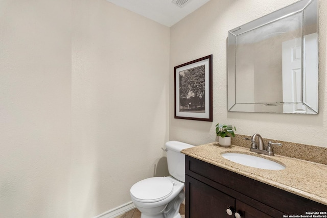 bathroom featuring toilet, visible vents, and vanity