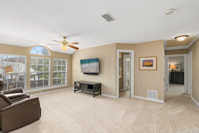 living area with baseboards, visible vents, and light colored carpet